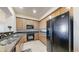 Well-equipped kitchen with sleek black appliances, granite countertops and hardwood cabinets at 2500 E Cherry Creek South Dr # 213, Denver, CO 80209