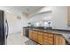 Well-lit kitchen features granite counters, wood cabinets, and modern appliances at 2500 E Cherry Creek South Dr # 213, Denver, CO 80209