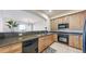 Cozy kitchen featuring granite countertops, tiled floors and wooden cabinets with modern appliances at 2500 E Cherry Creek South Dr # 213, Denver, CO 80209