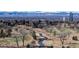 Scenic landscape view with a serene stream flowing under wooden bridges, surrounded by lush greenery and a city skyline backdrop at 2500 E Cherry Creek South Dr # 213, Denver, CO 80209