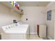 Bright laundry room features washer, dryer, storage shelf, and durable flooring, offering convenience and functionality at 2500 E Cherry Creek South Dr # 213, Denver, CO 80209