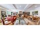 Elegant living room with cozy fireplace, bookshelves, and comfortable seating, ideal for relaxation and entertaining guests at 2500 E Cherry Creek South Dr # 213, Denver, CO 80209