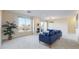 Bright living room with modern fireplace, blue sofa, and large windows showing exterior views at 2500 E Cherry Creek South Dr # 213, Denver, CO 80209