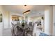 Inviting open-plan living and dining area featuring plush chairs, a large table, and an elegant chandelier at 2500 E Cherry Creek South Dr # 213, Denver, CO 80209
