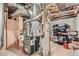 Basement with essential utilities, including a furnace, water heater, and exposed ductwork at 6776 E Panorama Ln # C1, Denver, CO 80224