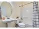 Bathroom with single sink, large mirror, and a shower/tub combo at 6776 E Panorama Ln # C1, Denver, CO 80224