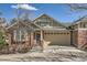 Inviting single-Gathering home featuring a classic brick facade and attached garage at 6776 E Panorama Ln # C1, Denver, CO 80224