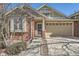 Welcoming brick home with a two-car garage and cozy front porch entrance at 6776 E Panorama Ln # C1, Denver, CO 80224