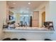 Modern kitchen with a granite breakfast bar and stainless steel microwave at 6776 E Panorama Ln # C1, Denver, CO 80224