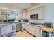 Bright kitchen with granite countertops, stainless steel appliances, and hardwood floors at 6776 E Panorama Ln # C1, Denver, CO 80224