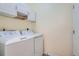 Functional laundry room with a washer, dryer, and overhead storage, designed for efficient chore management at 6776 E Panorama Ln # C1, Denver, CO 80224
