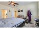 Relaxing main bedroom featuring a ceiling fan, ensuite bath, and neutral tones at 6776 E Panorama Ln # C1, Denver, CO 80224