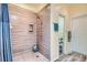 Updated shower with custom tile and a built-in niche for toiletries at 6776 E Panorama Ln # C1, Denver, CO 80224