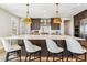 Spacious kitchen island with white countertop, pendant lighting, and seating for four at 3437 Vamoose Ct, Castle Rock, CO 80108