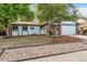 Ranch style home with brick facade, attached garage, and landscaped yard at 3754 S Mission Pkwy, Aurora, CO 80013