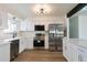 Modern kitchen with white cabinets, stainless steel appliances, and quartz countertops at 3754 S Mission Pkwy, Aurora, CO 80013