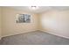 Neutral bedroom featuring a window for natural light and cozy gray carpeting at 7526 W Ottawa Pl, Littleton, CO 80128