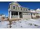 Two-story house with gray siding, stone accents, and a two-car garage at 24605 E 41St Ave, Aurora, CO 80019