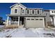 Two-story house with gray siding, stone accents, and a two-car garage at 24605 E 41St Ave, Aurora, CO 80019