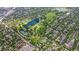 Stunning aerial view showcases a park with a lake, tennis courts, and lush green trees and residential neighborhoods at 1366 S Vine St, Denver, CO 80210