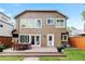 Backyard featuring a wood deck with outdoor seating, lawn, and mature trees at 1366 S Vine St, Denver, CO 80210