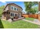 Backyard featuring a wood deck with outdoor seating, lawn, and mature trees at 1366 S Vine St, Denver, CO 80210
