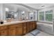 The primary bathroom is equipped with double sinks, and a soaking tub next to shuttered windows for natural light at 1366 S Vine St, Denver, CO 80210