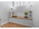 Built-in bench seat under window features a wood top, white storage cabinets, and modern wall sconces at 1366 S Vine St, Denver, CO 80210