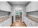 Butler's pantry with granite countertops, white cabinetry, and seamless transition to an elegant dining area at 1366 S Vine St, Denver, CO 80210