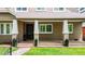Charming front porch featuring stone flooring, white columns, and a well-maintained landscaped yard at 1366 S Vine St, Denver, CO 80210