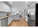 Bright open kitchen with granite countertops, stainless steel appliances, and hardwood floors at 1366 S Vine St, Denver, CO 80210