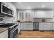 Well-lit kitchen featuring modern appliances, granite countertops, and a stylish white subway tile backsplash at 1366 S Vine St, Denver, CO 80210