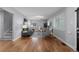 Bright living room featuring hardwood floors, gray walls, and lots of natural light from windows with white shutters at 1366 S Vine St, Denver, CO 80210
