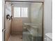 Tiled walk-in shower with glass door features a built-in bench and a shower head at 1366 S Vine St, Denver, CO 80210