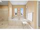 Bright bathroom featuring a large tub, shower, and decorative mirror at 4378 Fell Mist Way, Castle Rock, CO 80109