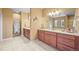 Spacious bathroom with double vanity, tiled floors, and neutral paint at 4378 Fell Mist Way, Castle Rock, CO 80109