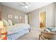 Comfortable bedroom featuring a four-poster bed, ceiling fan, and an ensuite bathroom entrance at 4378 Fell Mist Way, Castle Rock, CO 80109