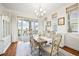 Bright dining room with a vintage table and chairs, chandelier, and sliding glass doors to the deck at 4378 Fell Mist Way, Castle Rock, CO 80109