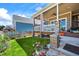 Charming porch with stone pillars, comfortable seating and lush lawn at 4378 Fell Mist Way, Castle Rock, CO 80109