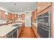 Spacious kitchen featuring wood cabinets, a large island, and modern appliances, perfect for cooking and entertaining at 4378 Fell Mist Way, Castle Rock, CO 80109