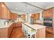 Well-equipped kitchen with wood cabinets, a spacious center island, and modern stainless steel appliances at 4378 Fell Mist Way, Castle Rock, CO 80109