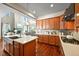 Stylish kitchen with wood cabinets, stone countertops, and an open layout connected to the living area at 4378 Fell Mist Way, Castle Rock, CO 80109