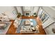 Bird's eye view of a living room with a fireplace, wood floors, couches, and blue rug at 4378 Fell Mist Way, Castle Rock, CO 80109