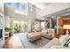 Open-concept living room with lots of natural light, a beautiful fireplace, and access to the outdoor porch at 4378 Fell Mist Way, Castle Rock, CO 80109