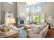 Cozy living room with a stone fireplace, large windows, and stylish furniture, perfect for relaxing at 4378 Fell Mist Way, Castle Rock, CO 80109