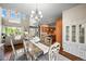 Open living space featuring a dining table, living room with large windows and access to the kitchen at 4378 Fell Mist Way, Castle Rock, CO 80109