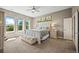 Comfortable main bedroom with large windows, ceiling fan, and neutral decor at 4378 Fell Mist Way, Castle Rock, CO 80109