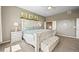 Comfortable main bedroom with bed, lamps, and views of the outside at 4378 Fell Mist Way, Castle Rock, CO 80109