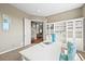 Spacious office with large windows, open shelving, and comfortable seating area at 4378 Fell Mist Way, Castle Rock, CO 80109