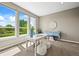 Inviting home office featuring large windows, stylish decor, and ample natural light at 4378 Fell Mist Way, Castle Rock, CO 80109